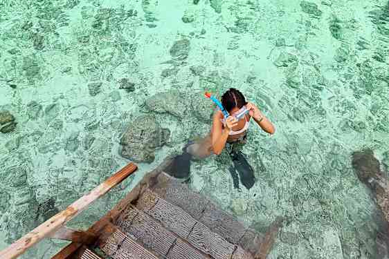 Woman dives in the ocean