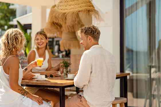 Men and women laughing at table
