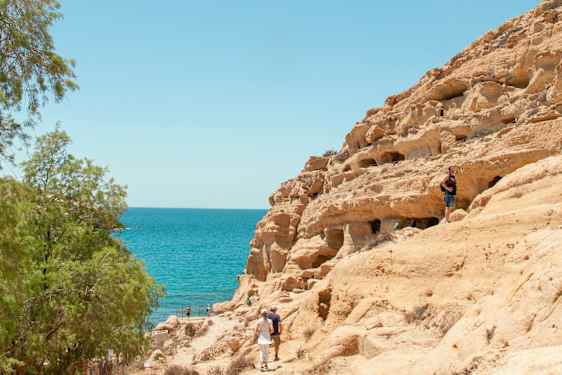 Couple walking by the cliffs 