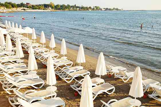 Beach with sunbeds by the sea