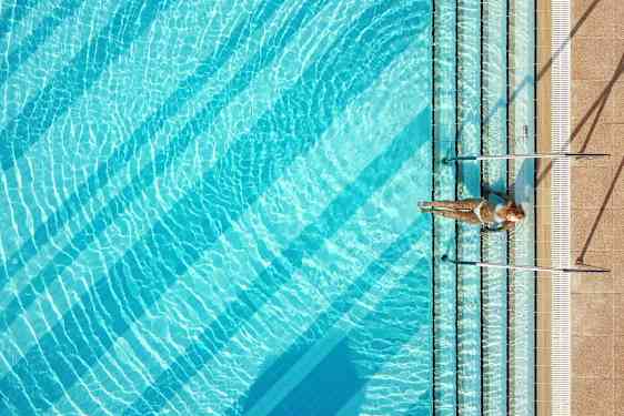 Woman sitting on poolside