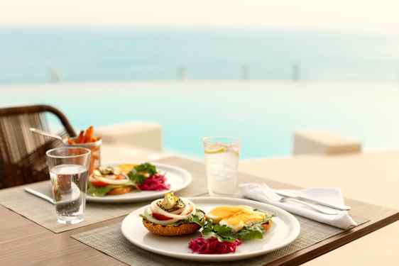 Food on table by the pool