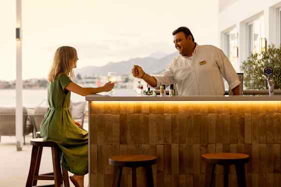 Two girls drinking juice at bar