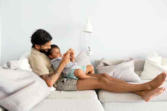 Dad in sofa with in knee