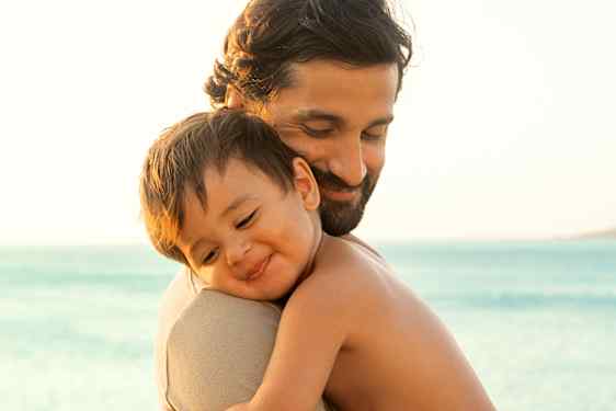 Baby leaning on dads shoulder