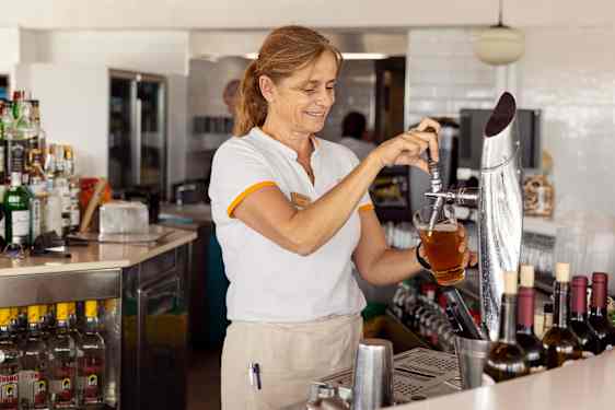 Bar staff pouring beer