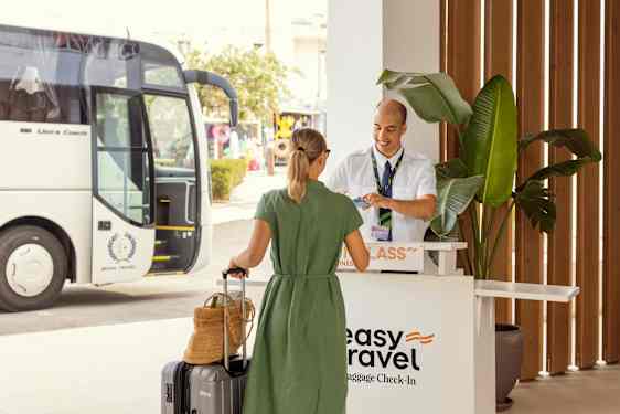 Woman with bags by transferbus