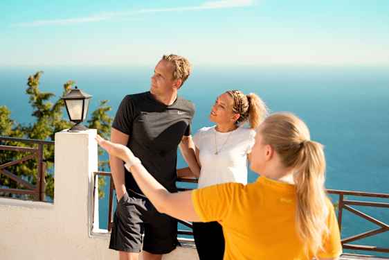 Guide pointing out the direction for two guests 