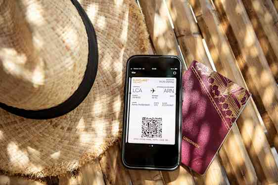 Woman holdin passport and ticket and drags suitecase