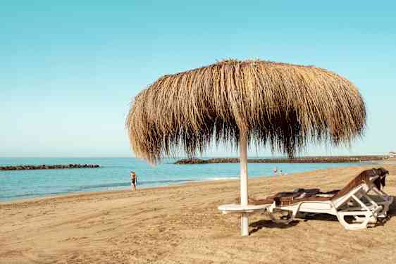 Beach with sunbeds and umbrella