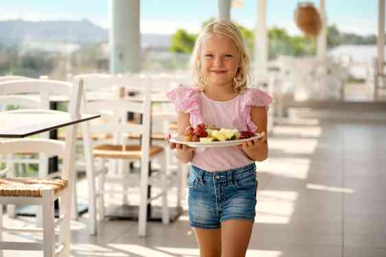 Girl walking with plate in restaurant