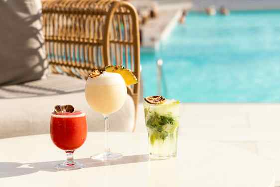 Thre colorful drinks by the pool