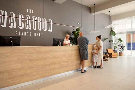 Family talking to receptionist