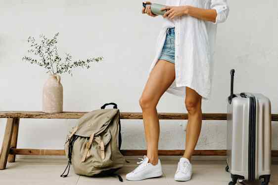 Woman in lobby with bag and backpack