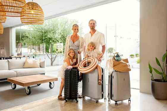 Family with bags in lobby