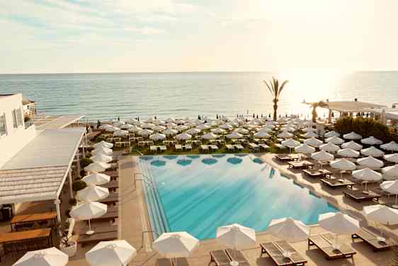 Poolarea with white umbrellas