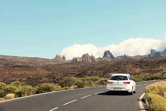 White car on road among mountains on Tenerife