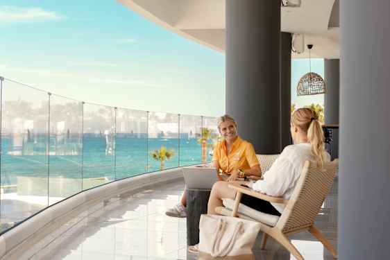 Staff talking to guest in balcony