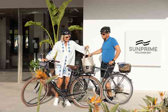 Woman and man with bikes outside the hotel entrance