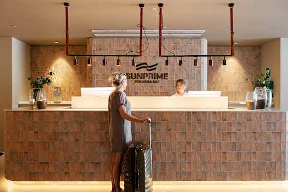 Staff helps guest out in reception