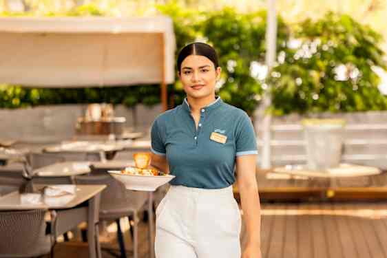Staff carrying plate with food in restaurant