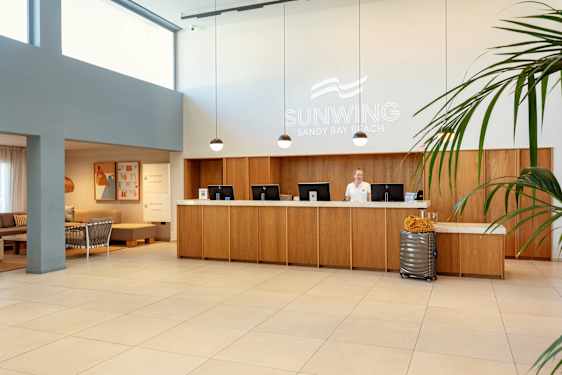 Receptionist behind reception counter in lobby