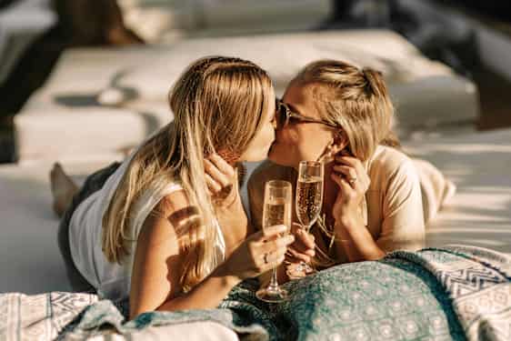 Couple kissing and cheering in champagne