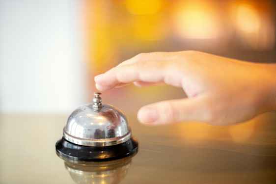 Hand ringing bell on counter