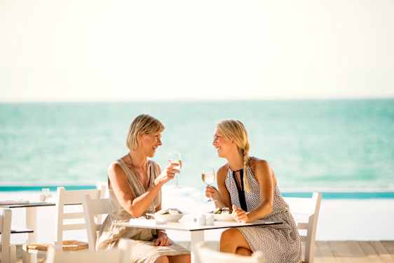 Men and women laughing at table