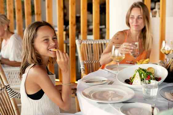 Girl and mother at dinner table