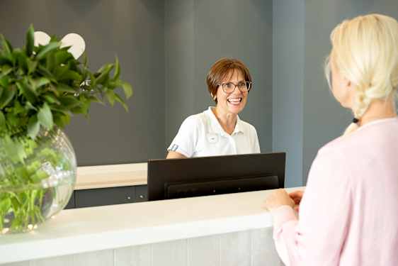Staff helps guest out in reception
