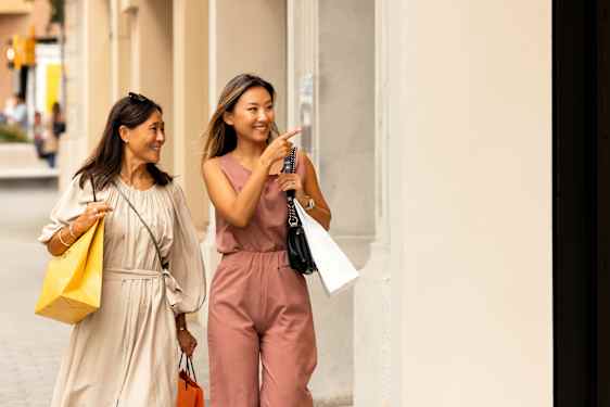Two women with bags shopping