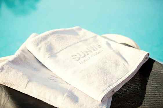 White sunwing towels by the pool