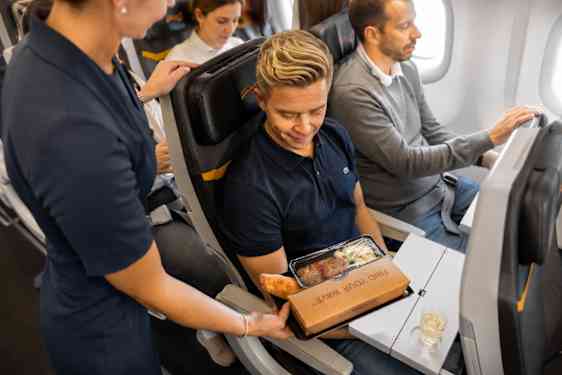 Flygvärdinna serverar mat ombord Sunclass Airlines