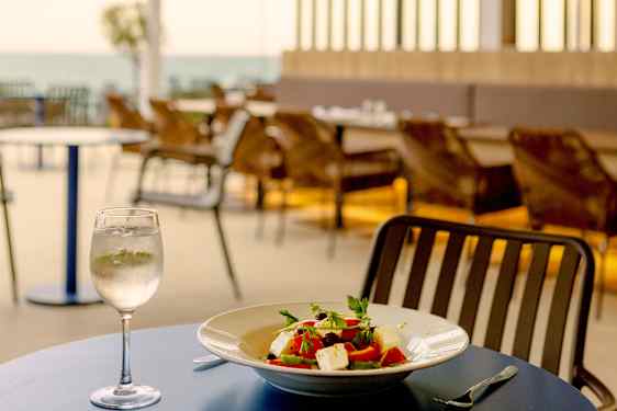 Food and wine at table by the sea