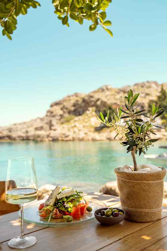 Food and wine at table by the sea